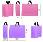 El regalo plástico grueso del PVC del empaquetado del paño, de los bolsos de la ropa, del rosa de la mercancía y de la púrpura empaqueta bolsos de compras al por menor de la ropa